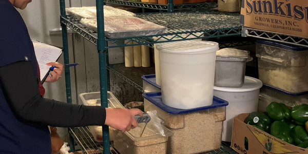 Health Department staff member conducting a food inspection. Health Department staff member conducting a food inspection.