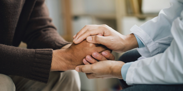 Hands of people supporting one another