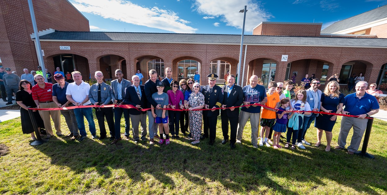 Image of ribbon cutting in front of the Lorton Campus
