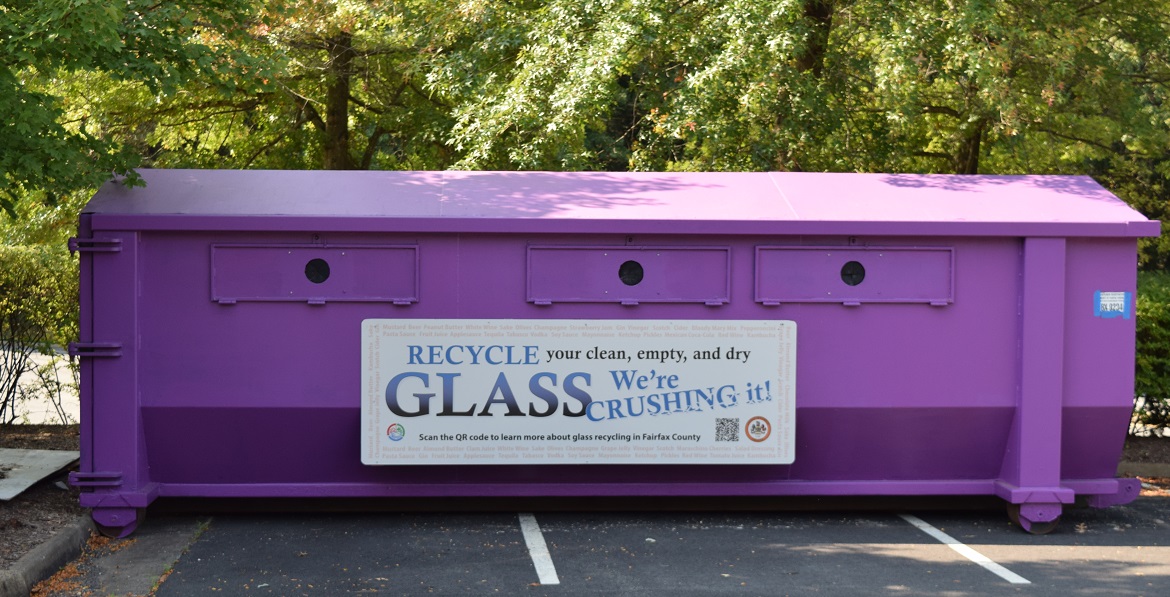 purple bin for glass container recycling, in parking lot