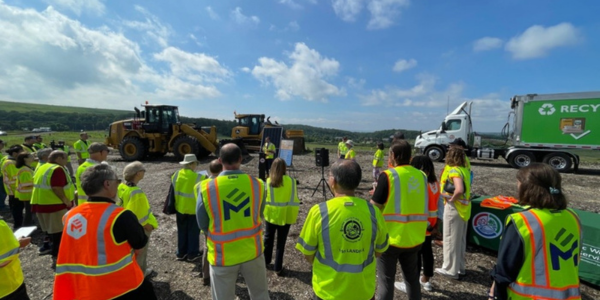 A group of staff in high-visibility vests gather at the I-95 landfill A group of staff in high-visibility vests gather at the I-95 landfill