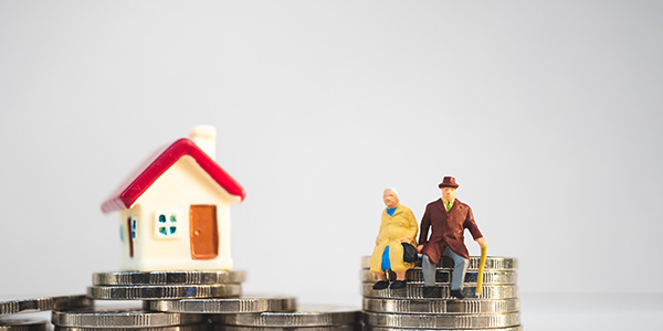 Photo of a house. Photo of a house on a pile of coins.