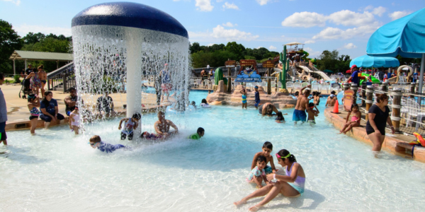 watermine pool with children in it on a blue sky day