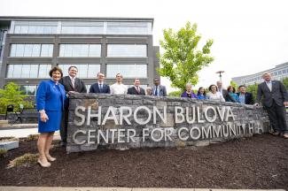 photo of Sharon Bulova and other officials standing near new Sharon Bulova Center sign