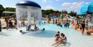 watermine pool with children in it on a blue sky day