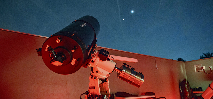 A telescope points into the sky at a distant star