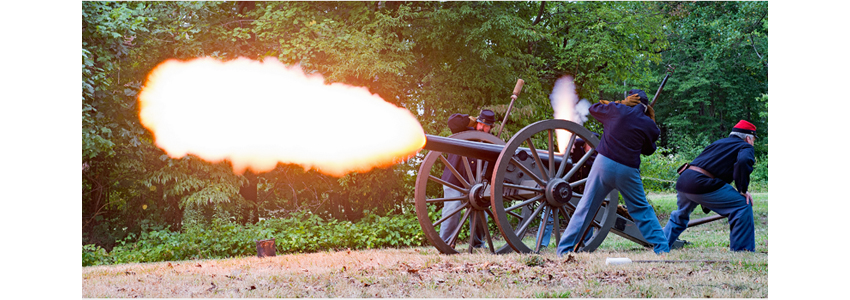 Civil War re-enactors fire a cannon
