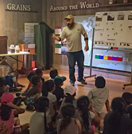 Instructor teaches children about grains around the world.
