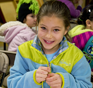 Girl Scout sewing during a scout program