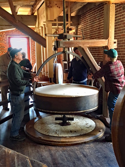 Staff readies a grinding stone for the first grind of the year