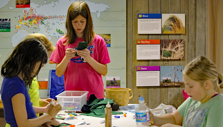 Girl Scouts work on an art program inside the Colvin Run Mill barn