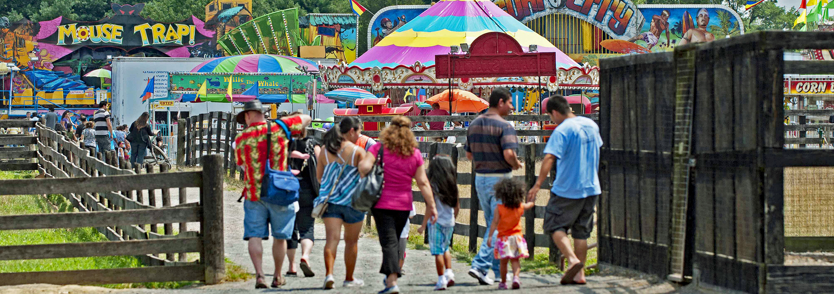 A family enters the gate at the 4-H Fair