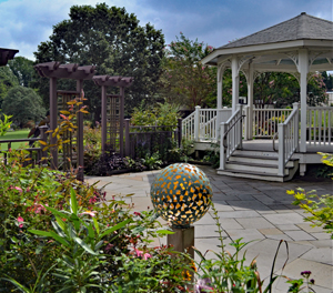 A gazebo surrounded by blooming flowers