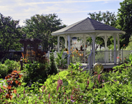 Gazebo surrounded by blooming flowers
