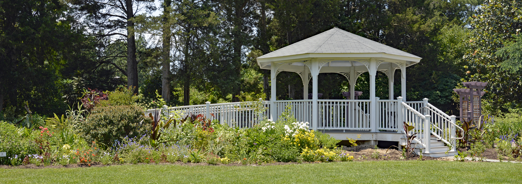 Flowers bloom around a gazebo