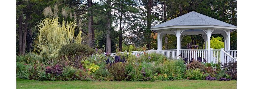 Green Spring gazebo surrounded by blooming flowers