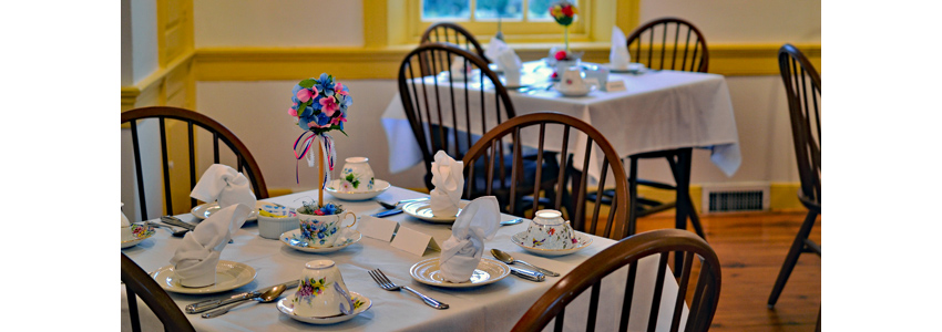 Tables, chairs and table settings prepared for a formal tea