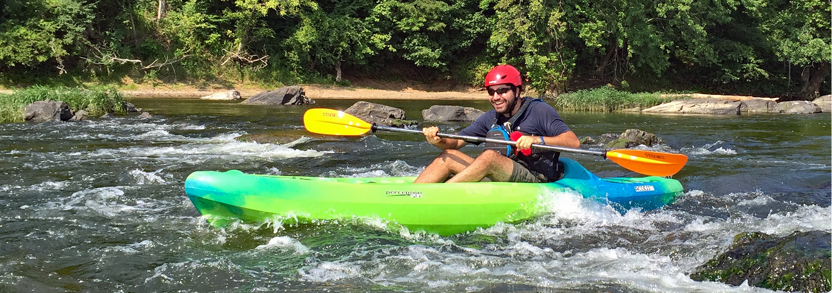 A kayaker runs a rapids near Riverbend Park