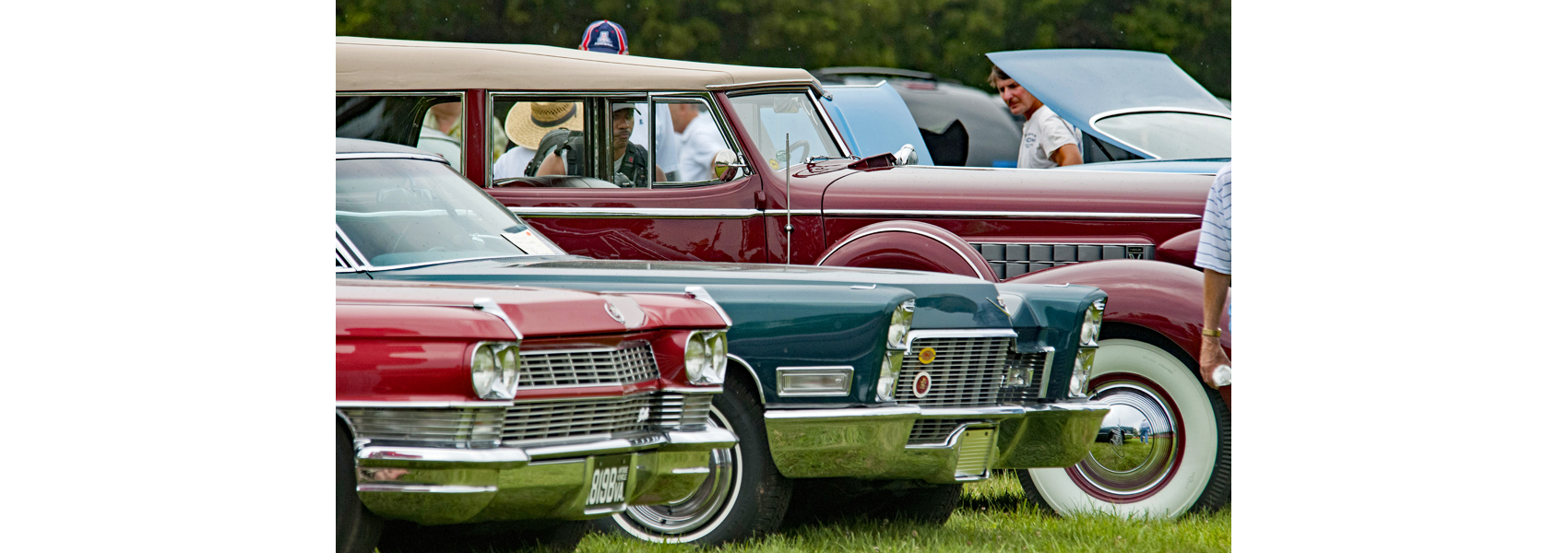 Several antique cars parked in a line