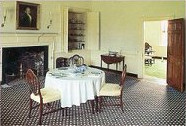 Table and chairs in front of a fireplace