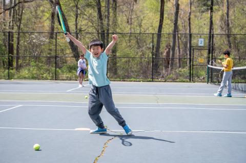 kid playing tennis