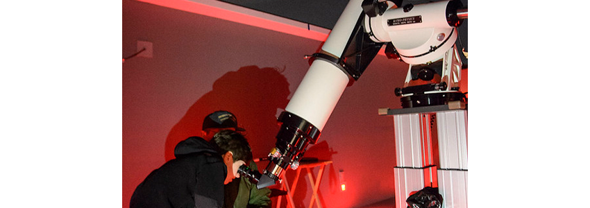 child using the observatory telescope