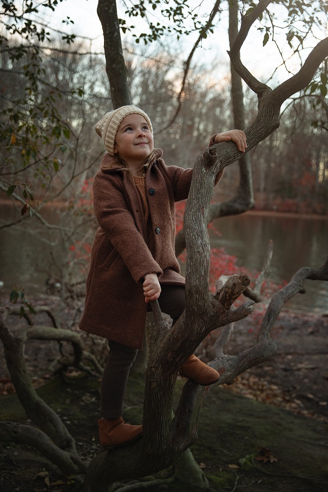girl sitting on log