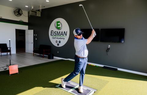 Golfer takes a swing