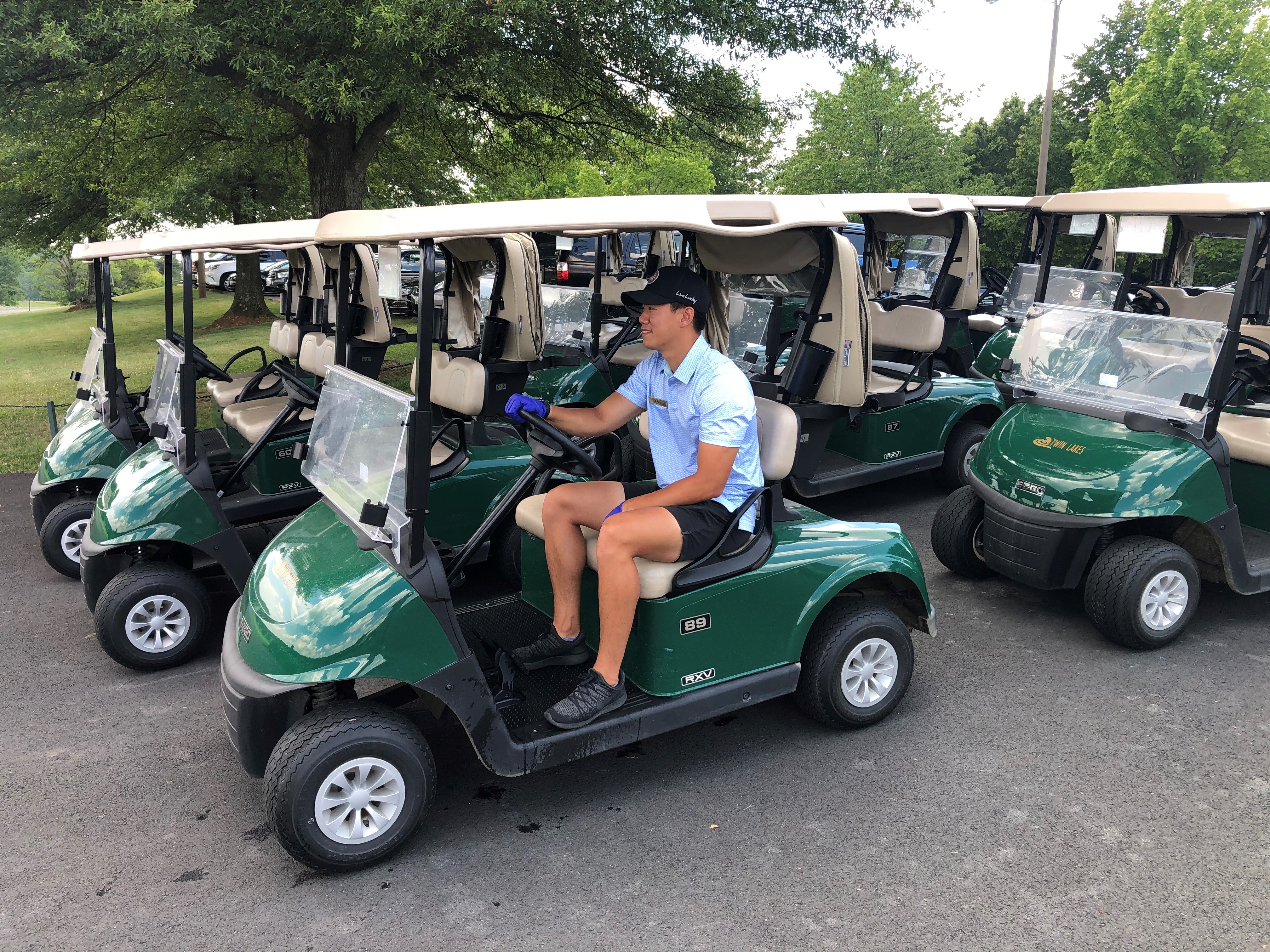 Golf staff in power cart