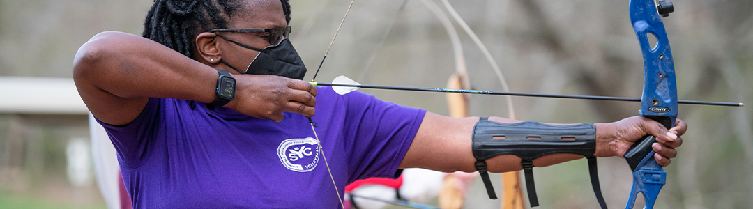 a woman participating in an archery class
