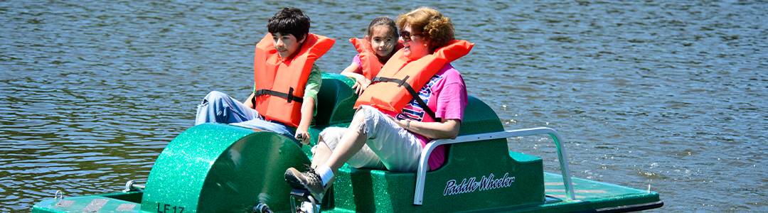 a family out on the water in a paddleboat at Lake Fairfax Park