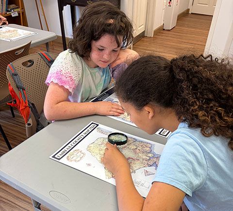 image of kids studying a map