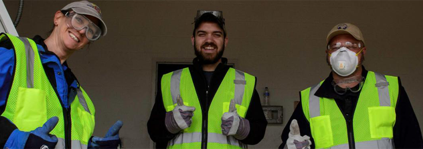 three Park Operations employees in high-visibility vests