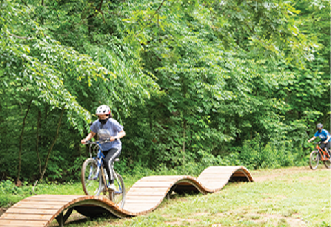 a bicyclist using the pump track at Brookfield Park
