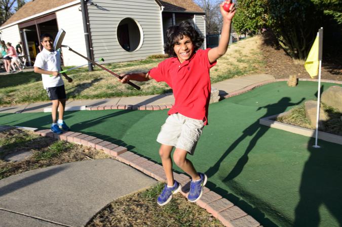 Kids playing mini golf