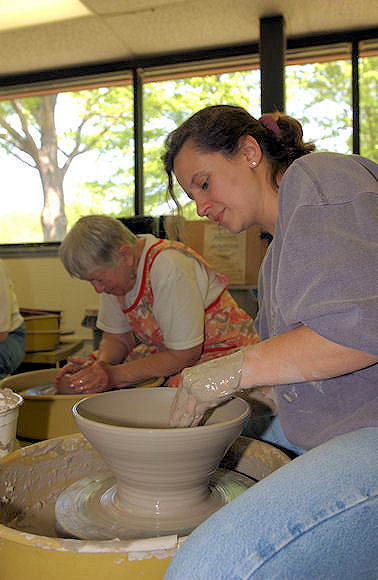 Potter making a pot on a potters wheel