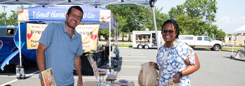 a vendor and customer at Kingstowne Farmers Market