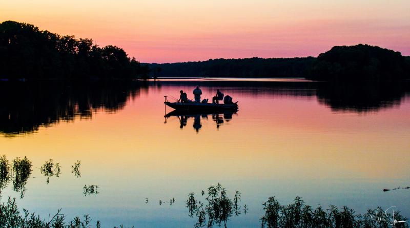 image of people on a boat at lake