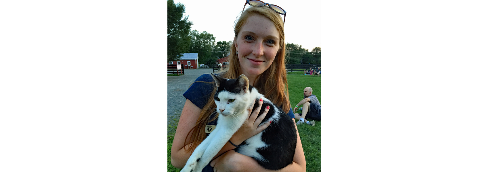 Volunteer at Frying Pan Farm Park holds a cat