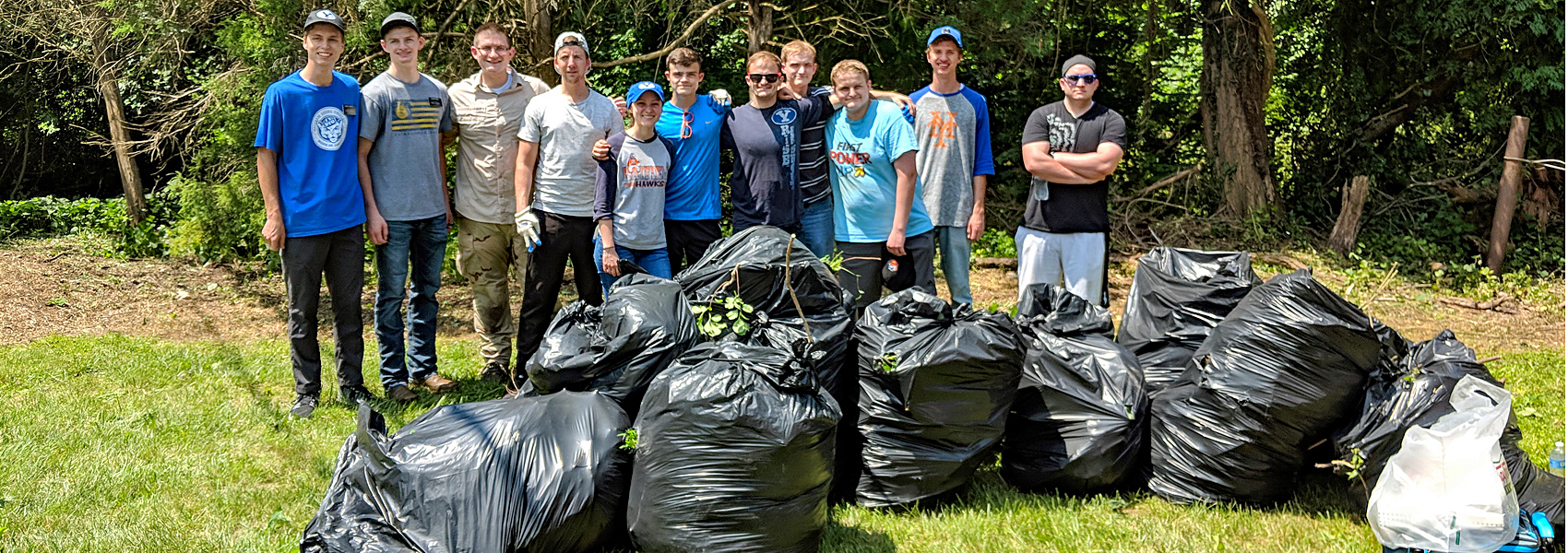 Park cleanup crew poses with about a dozen bags of trash