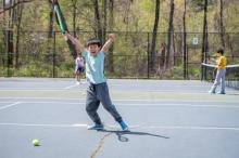 kid playing tennis
