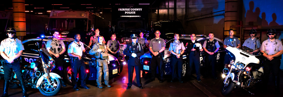 officers from various police department divisions pose in front of various police vehicles