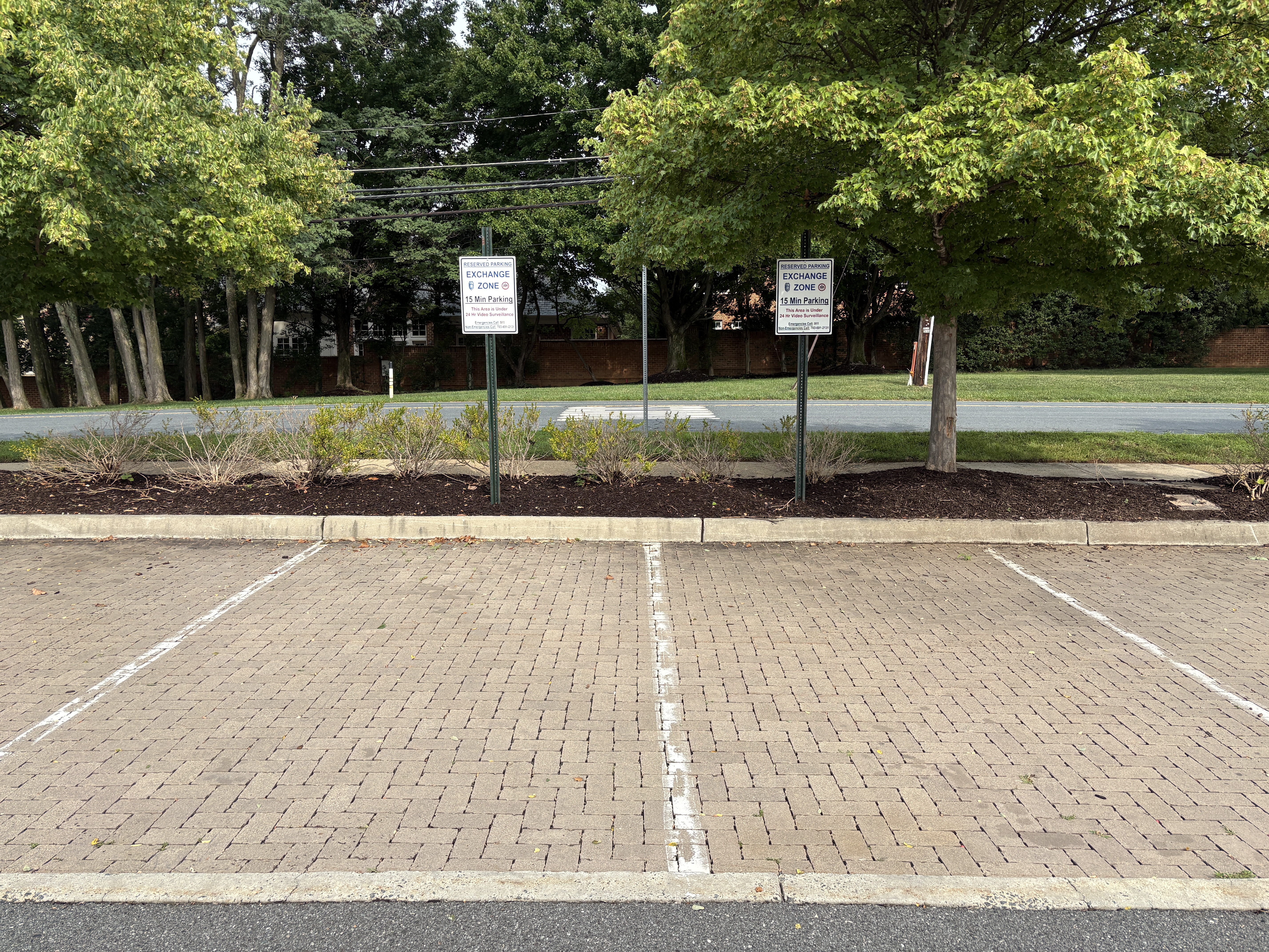 Marked Safe Exchange Zone parking spaces in front of a district police station