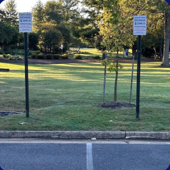 Marked Safe Exchange Zone parking spaces in front of a district police station