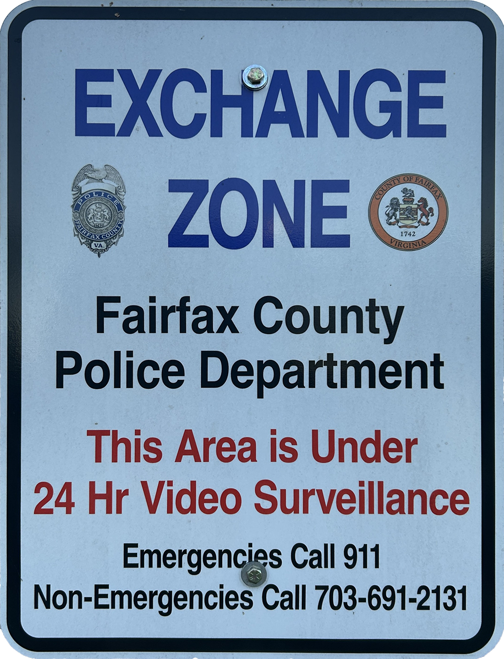 Exchange Zone sign: Fairfax County Police Department, this area is under 24-hour video surveillance