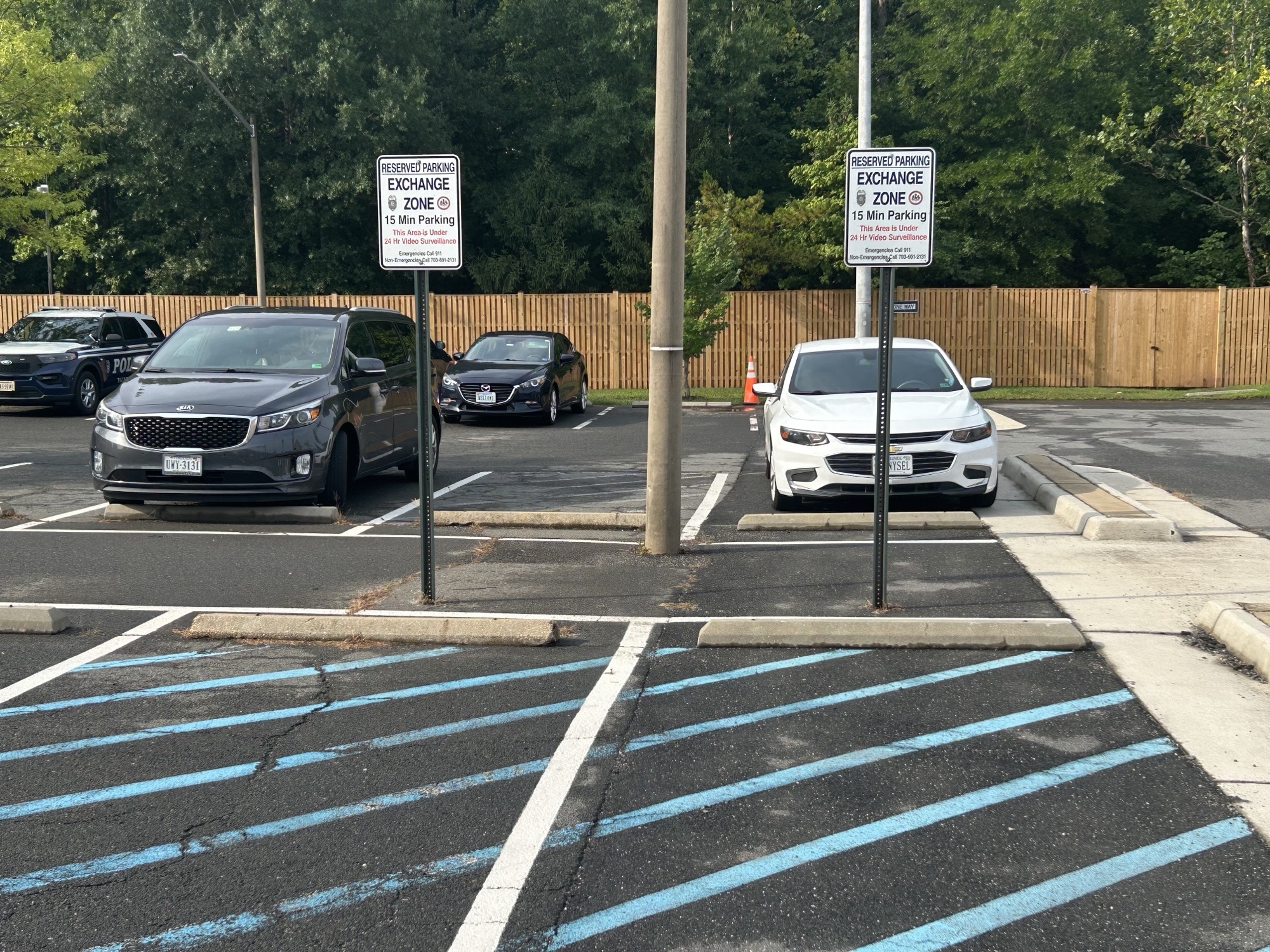 Marked Safe Exchange Zone parking spaces in front of a district police station