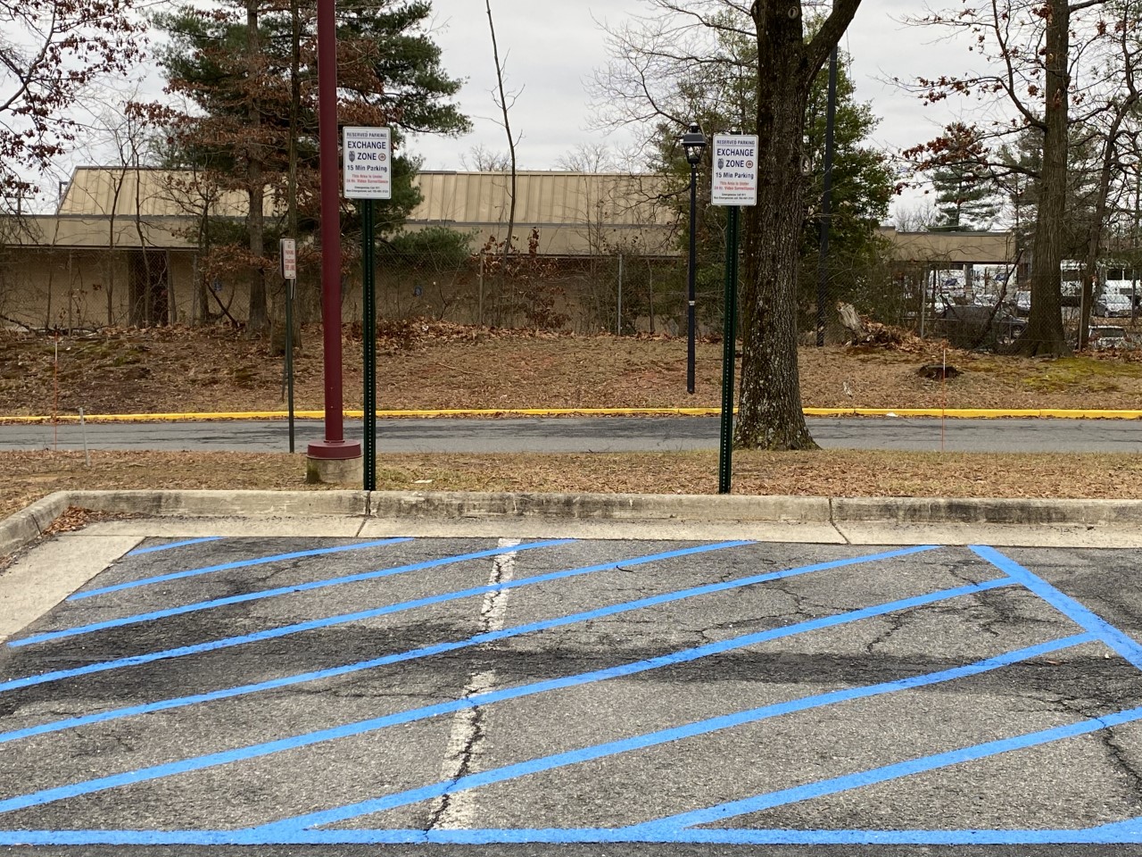 Marked Safe Exchange Zone parking spaces in front of a district police station