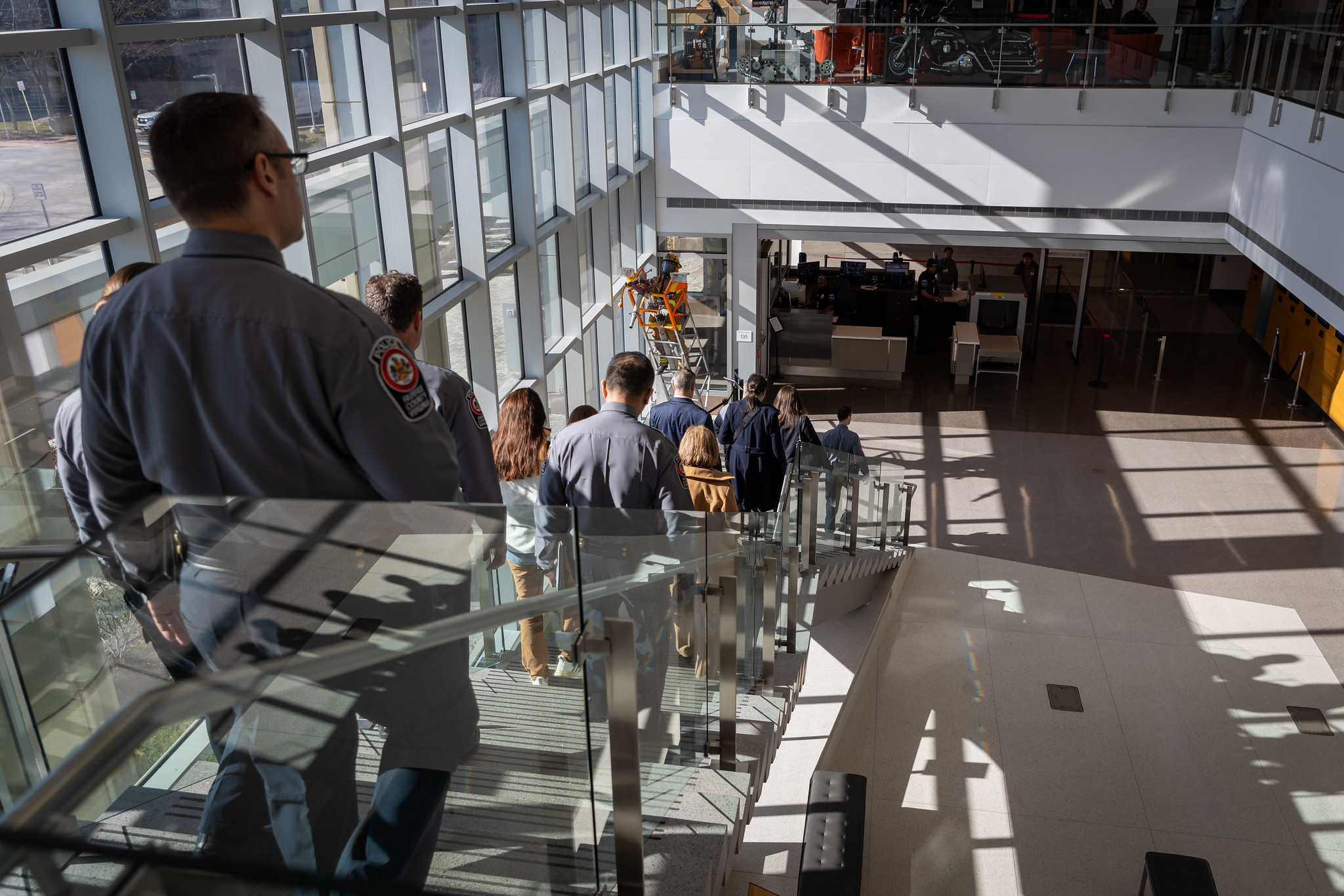 photo of people on the stairwell from the second floor leading to the first floor