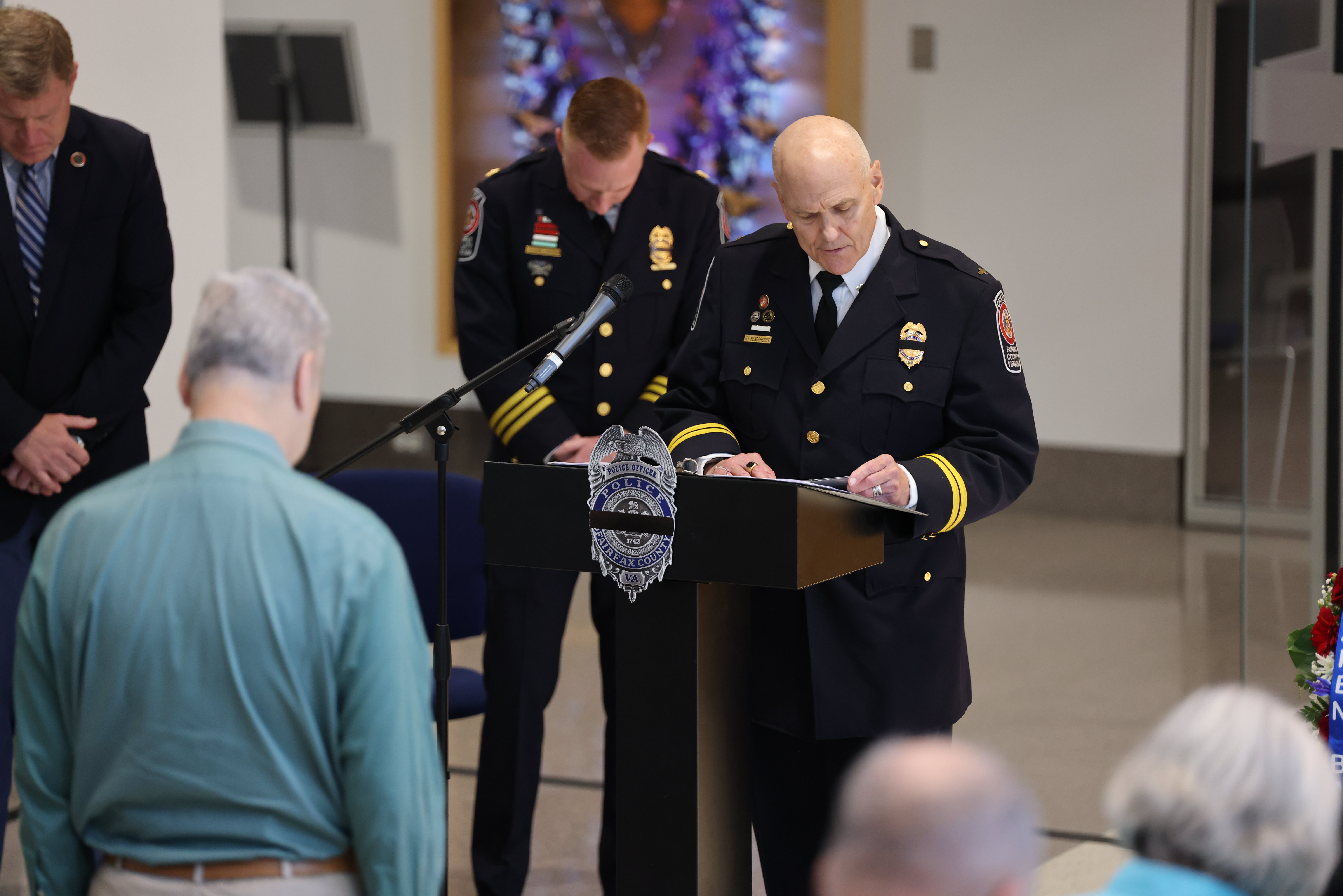 A Fairfax County Police Department Chaplain speaking at a memorial