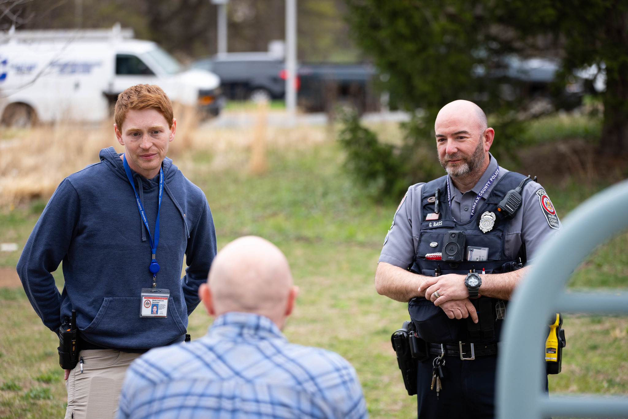 crisis intervention team talking to a person sitting on a bench